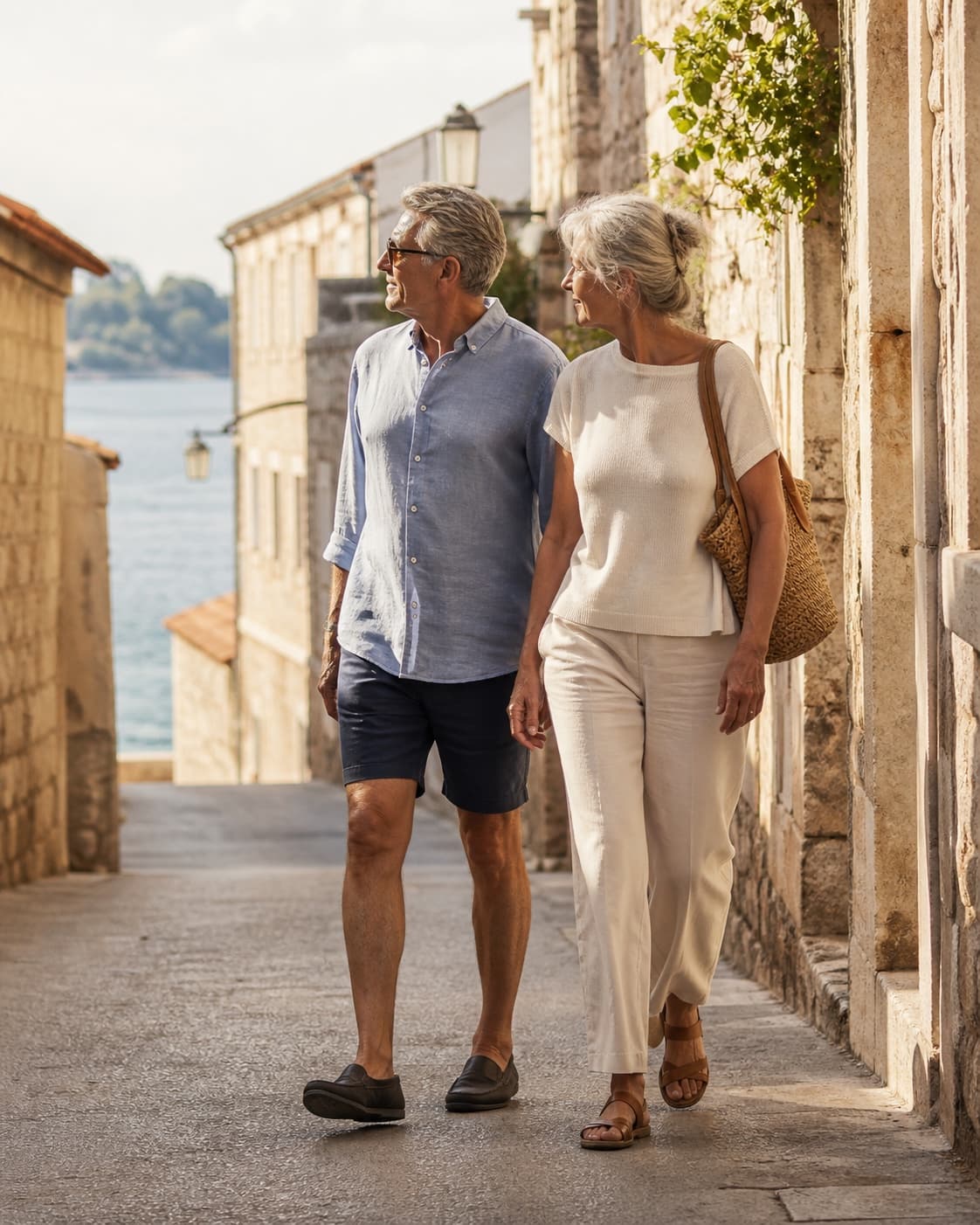 A couple exploring a coastal town together on foot